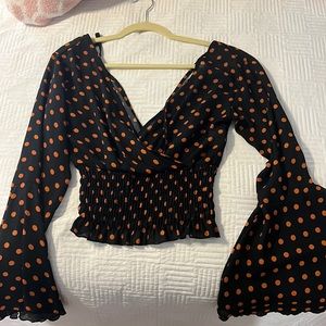 Long sleeve orange and black polka dot shirt